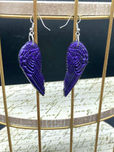 Load image into Gallery viewer, Sparkling dark purple angel wings earrings made of polymer clay.  These earrings are designed to face forward when worn instead of the front wings showing on the side.
