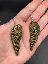 Load image into Gallery viewer, Sparkling gold tone angel wings earrings made of polymer clay.  These earrings are designed to face forward when worn instead of the front wings showing on the side.
