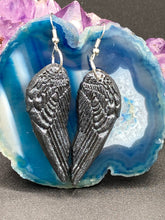 Load image into Gallery viewer, Chrome-colored silver angel wings earrings crafted with polymer clay. Featuring a construction designed to ensure the front wings face forward when worn.
