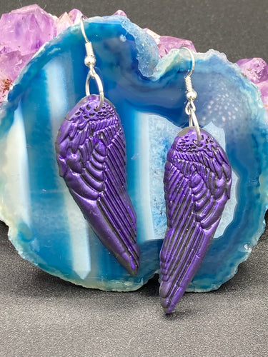 Sparkling dark purple angel wings earrings made of polymer clay.  These earrings are designed to face forward when worn instead of the front wings showing on the side.