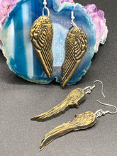Load image into Gallery viewer, Sparkling gold tone angel wings earrings made of polymer clay.  These earrings are designed to face forward when worn instead of the front wings showing on the side.
