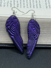 Load image into Gallery viewer, Sparkling dark purple angel wings earrings made of polymer clay.  These earrings are designed to face forward when worn instead of the front wings showing on the side.
