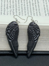 Load image into Gallery viewer, Shimmery black angel wings earrings made of polymer clay.  These earrings are designed to face forward when worn instead of the front wings showing on the side.
