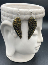 Load image into Gallery viewer, Sparkling gold tone angel wings earrings made of polymer clay.  These earrings are designed to face forward when worn instead of the front wings showing on the side.
