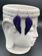 Load image into Gallery viewer, Sparkling dark purple angel wings earrings made of polymer clay.  These earrings are designed to face forward when worn instead of the front wings showing on the side.
