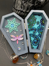 Load image into Gallery viewer, Handmade Vintage Inspired Gothic Victorian Coffin Jewelry Box. Black Wood Coffin Ring Box, Seafoam Blue Star Shape Veneer Floral Embellishment. Dark and whimsical theme keepsake box with dragonfly and shimmer gems. Starry Night Jewelry Box. Interior lined mandala pattern fabric. Holds several rings or jewelry pieces. Dark, Beautiful, Unique Gift for the BOLD. Makes a great keepsake box! Or you could also just let your cat admire it before he knocks it off the table, too.
