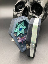 Load image into Gallery viewer, Handmade Vintage Inspired Gothic Victorian Coffin Jewelry Box. Black Wood Coffin Ring Box, Seafoam Blue Star Shape Veneer Floral Embellishment. Dark and whimsical theme keepsake box with dragonfly and shimmer gems. Starry Night Jewelry Box. Interior lined mandala pattern fabric. Holds several rings or jewelry pieces. Dark, Beautiful, Unique Gift for the BOLD. Makes a great keepsake box! Or you could also just let your cat admire it before he knocks it off the table, too.
