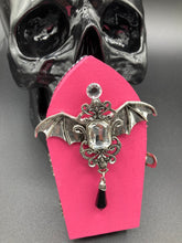 Load image into Gallery viewer, This unique handmade Pink Spooky Glam Wood Coffin Ring Box offers a statement piece for your witchy home decor. Its macabre collections boast a black and pink wood coffin with large shimmery bat embellishments and decorative black crystals around the exterior. Open up the box to find a bright turquoise mandala fabric and a tiny black crystal bat decoration for a truly eerie feel.
