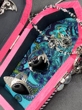 Load image into Gallery viewer, This unique handmade Pink Spooky Glam Wood Coffin Ring Box offers a statement piece for your witchy home decor. Its macabre collections boast a black and pink wood coffin with large shimmery bat embellishments and decorative black crystals around the exterior. Open up the box to find a bright turquoise mandala fabric and a tiny black crystal bat decoration for a truly eerie feel.
