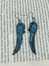 Load image into Gallery viewer, Sparkling light blue angel wings earrings made of polymer clay.  These earrings are designed to face forward when worn instead of the front wings showing on the side.
