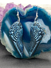 Load image into Gallery viewer, Sparkling light blue angel wings earrings made of polymer clay.  These earrings are designed to face forward when worn instead of the front wings showing on the side.
