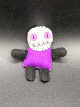 Load image into Gallery viewer, Mini socially awkward black and purple Voodoo Doll stands at 2 3/4&quot; in height.  He has a bright purple torso with black limbs and a large white head and matching purple biddy eyes.  
