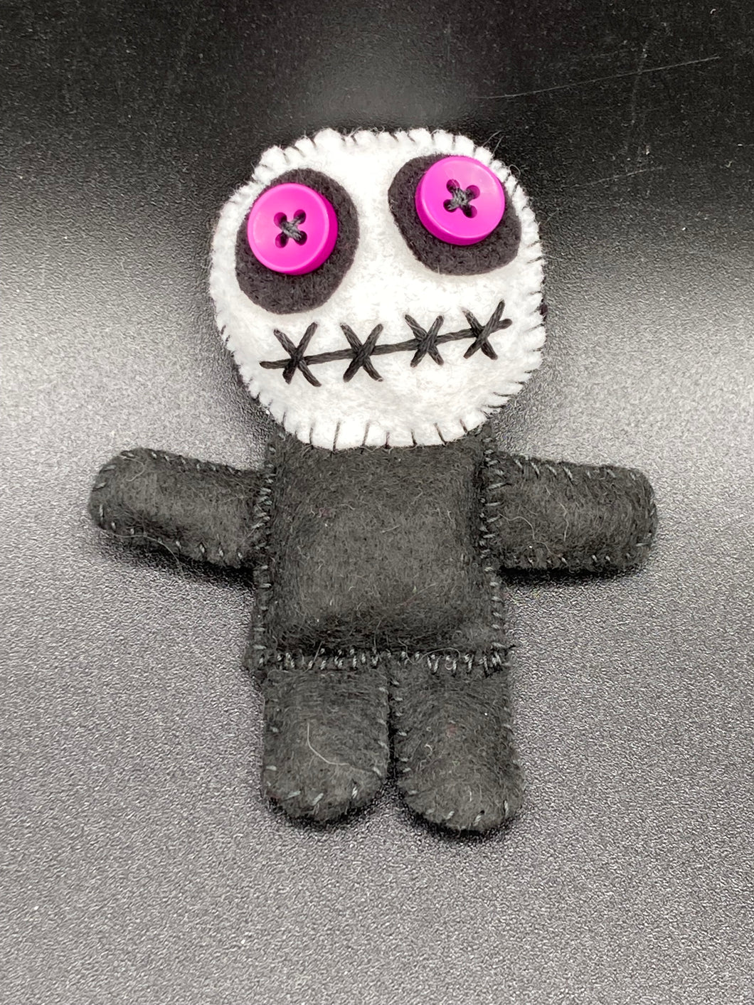 Creepy black and purple  Voodoo Doll stands tall at 3 3/8