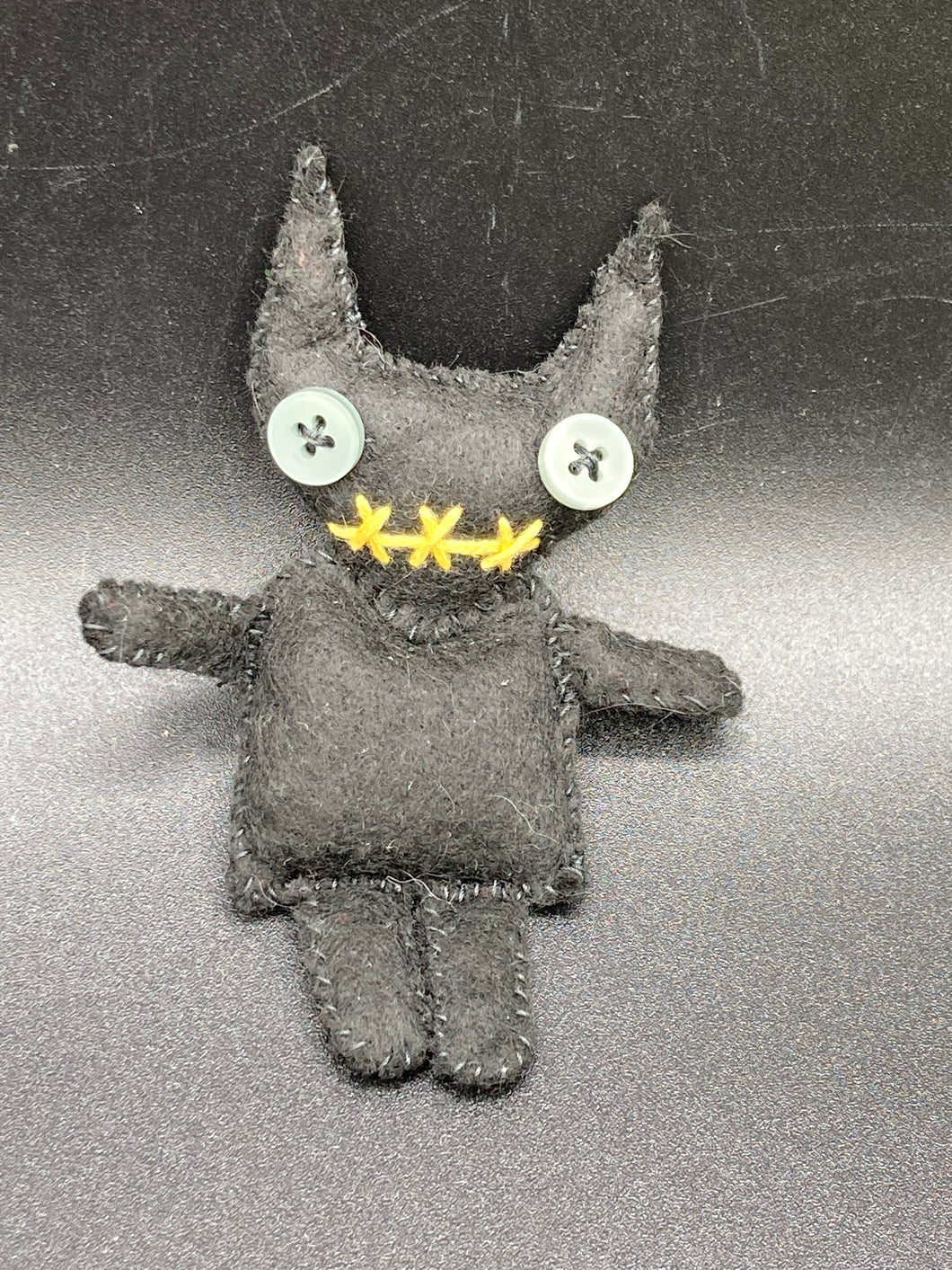 Black Devil Voodoo Doll has yellow mouth and cute little black horns of course, white buttons for eyes: 3 3/8