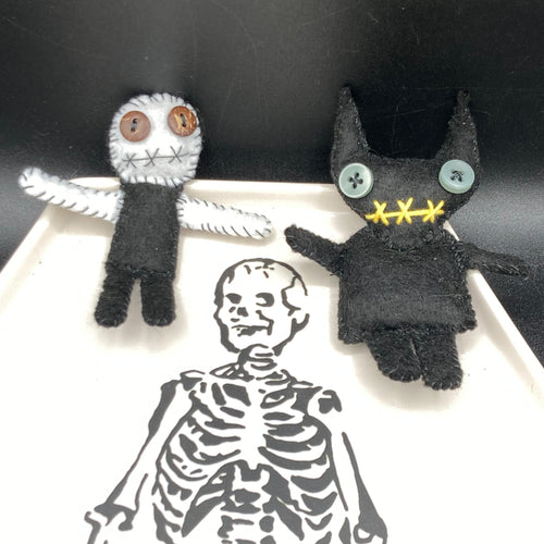  Skinny black and white Voodoo Doll stands at 3 7/8