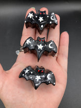Load image into Gallery viewer, Cute and spooky magnet design to adorn your refrigerator, lockers, workstation, toolbox, or dishwasher. This hand-sculpted clay all black bat statuette has white crescent moon and stars to recreate a starry night sky. H 1” x W 2” x D 1/2”

