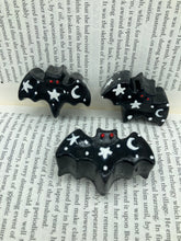 Load image into Gallery viewer, Cute and spooky magnet design to adorn your refrigerator, lockers, workstation, toolbox, or dishwasher. This hand-sculpted clay bat statuette all black with white stars to recreate a starry night sky. H 1” x W 2” x D 1/2”
