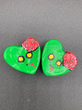 Load image into Gallery viewer, Perfect cute and spooky Halloween item to add to your fridge, locker, cubicle or toolbox. This handcrafted, bright green, heart-shaped magnet features an intricate, exposed brains-inspired zombie design.  Measurements: H 1 1/2” x W 1 5/8” x D 1/2”
