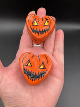 Load image into Gallery viewer, Perfect cute and spooky Halloween item to add to your fridge, locker, cubicle or toolbox.   This hand-crafted bright orange heart-shaped magnet showcases a Jack o Lantern inspired design.  Measurements: H 1 1/2” x W 1 5/8” x D 1/2”

