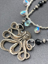 Load image into Gallery viewer, This Steampunk Metal Octopus Double Strand Bead Adjustable Necklace is a stylish and unique addition to any collection. Crafted with vivid iridescent teardrop and glass beads, this stylish jewelry also features a highly detailed metal octopus pendant. Strands of beads are designed to interweave without tangling for a truly eye-catching look.   Measurements:  Necklace measures 16 1/2” adjustable up to 18”
