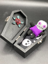 Load image into Gallery viewer, Mini socially awkward black and purple Voodoo Doll stands at 2 3/4&quot; in height.  He has a bright purple torso with black limbs and a large white head and matching purple biddy eyes.  
