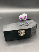 Load image into Gallery viewer, Mini socially awkward black and purple Voodoo Doll stands at 2 3/4&quot; in height.  He has a bright purple torso with black limbs and a large white head and matching purple biddy eyes.  
