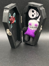 Load image into Gallery viewer, Mini socially awkward black and purple Voodoo Doll stands at 2 3/4&quot; in height.  He has a bright purple torso with black limbs and a large white head and matching purple biddy eyes.  

