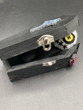 Load image into Gallery viewer,  Creepy black and white Voodoo Doll stands tall at 4&quot; in height.  He’s all black like a shadow but has a round white head.  Bright yellow buttons eyes are perfect to see you better with.
