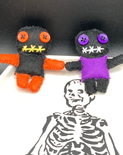 Short and tiny black and purple Voodoo Doll is 3