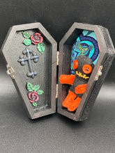 Load image into Gallery viewer, Short and tiny black and orange Voodoo Doll is 3&quot; in height.  Torso and head is all black while legs and arms are bright orange, perfect Halloween colors. He has matching bright orange buttons for eyes and has a sowed shut mouth.
