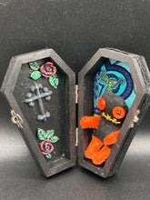 Load image into Gallery viewer, Short and tiny black and orange Voodoo Doll is 3&quot; in height.  Torso and head is all black while legs and arms are bright orange, perfect Halloween colors. He has matching bright orange buttons for eyes and has a sowed shut mouth.
