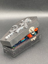Load image into Gallery viewer, Short and tiny black and orange Voodoo Doll is 3&quot; in height.  Torso and head is all black while legs and arms are bright orange, perfect Halloween colors. He has matching bright orange buttons for eyes and has a sowed shut mouth.
