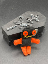 Load image into Gallery viewer, Short and tiny black and orange Voodoo Doll is 3&quot; in height.  Torso and head is all black while legs and arms are bright orange, perfect Halloween colors. He has matching bright orange buttons for eyes and has a sowed shut mouth.
