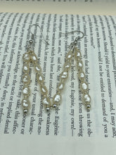 Load image into Gallery viewer, Two long strands of simulated white baroque pearls and silver glass beads come together to create this exquisite accessory.  Measurements: 2” in length 
