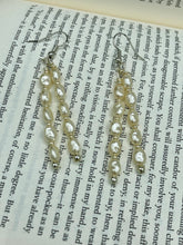 Load image into Gallery viewer, Two long strands of simulated white baroque pearls and silver glass beads come together to create this exquisite accessory.  Measurements: 2” in length 
