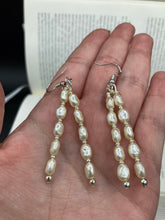 Load image into Gallery viewer, Two long strands of simulated white baroque pearls and silver glass beads come together to create this exquisite accessory.  Measurements: 2” in length 
