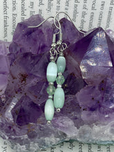 Load image into Gallery viewer, Dainty pastel green glass beaded earringsThese dainty pastel green glass beaded earrings add a unique and eye-catching touch to any look, making them the perfect bohemian accessory. Their shabby boho chic design is both comfortable and elegant, making them the ideal choice for any occasion. Measurements: 1 1/4” in length 
