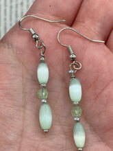 Load image into Gallery viewer, Dainty pastel green glass beaded earringsThese dainty pastel green glass beaded earrings add a unique and eye-catching touch to any look, making them the perfect bohemian accessory. Their shabby boho chic design is both comfortable and elegant, making them the ideal choice for any occasion. Measurements: 1 1/4” in length 
