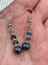 Load image into Gallery viewer, These stunning hematite and glass beaded earrings are a perfect combination of shabby boho chic and bohemian style. The round hematite beads are beautifully complemented by the light blue triangle shaped glass beads, for an eye-catching accessory that is sure to draw attention.  Measurements: 1 1/4” in length
