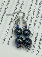 Load image into Gallery viewer, These chic earrings, crafted with two Hematite beads and blue glass beads, provide a stylish accent.  Measurements: 1 1/4” in length
