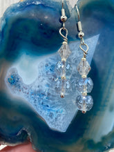 Load image into Gallery viewer, These gorgeous earrings boast three shimmering beads of round iridescent and silver glass.  Measurements: 1 1/4” in length
