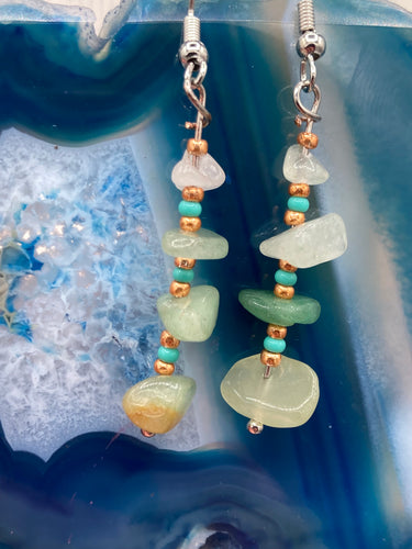 This simple yet elegant set of earrings features a single strand of natural green aventurine chip stones, accented by small turquoise and gold glass beads. Measurements: 1 1/2” in length 