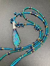 Load image into Gallery viewer, This celestial and galaxy goddess necklace features two strands of glass beading and a captivating Kyanite wired stone pendant. Its mixture of shimmering purples, blues, greens, and golds is truly striking and provides an alluring look like no other. Add this bold and beautiful jewelry piece to your collection today for a statement look that truly stands out. Necklace is 15” in length, can be adjusted to 18&quot;
