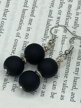 Load image into Gallery viewer, These two-bead flat matte black glass earrings are perfect for any look. With their subtle yet elegant design, they are a great accessory for any closet. 1 1/4” in length
