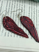 Load image into Gallery viewer, Red angel wings earrings made of polymer clay.  These earrings are designed to face forward when worn instead of the front wings showing on the side.
