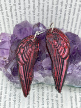 Load image into Gallery viewer, Red angel wings earrings made of polymer clay.  These earrings are designed to face forward when worn instead of the front wings showing on the side.
