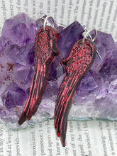 Load image into Gallery viewer, Red angel wings earrings made of polymer clay.  These earrings are designed to face forward when worn instead of the front wings showing on the side.
