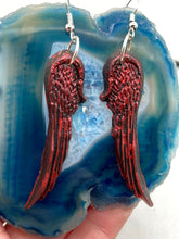 Load image into Gallery viewer, Red angel wings earrings made of polymer clay.  These earrings are designed to face forward when worn instead of the front wings showing on the side.
