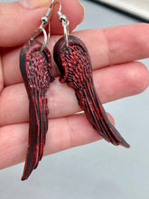 Load image into Gallery viewer, Red angel wings earrings made of polymer clay.  These earrings are designed to face forward when worn instead of the front wings showing on the side.
