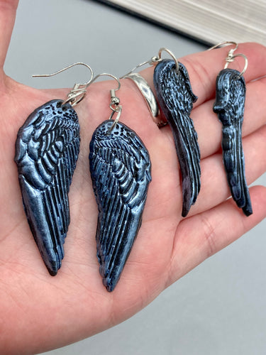 Shimmery silver color angel wings earrings made of polymer clay.  These earrings are designed to face forward when worn instead of the front wings showing on the side.